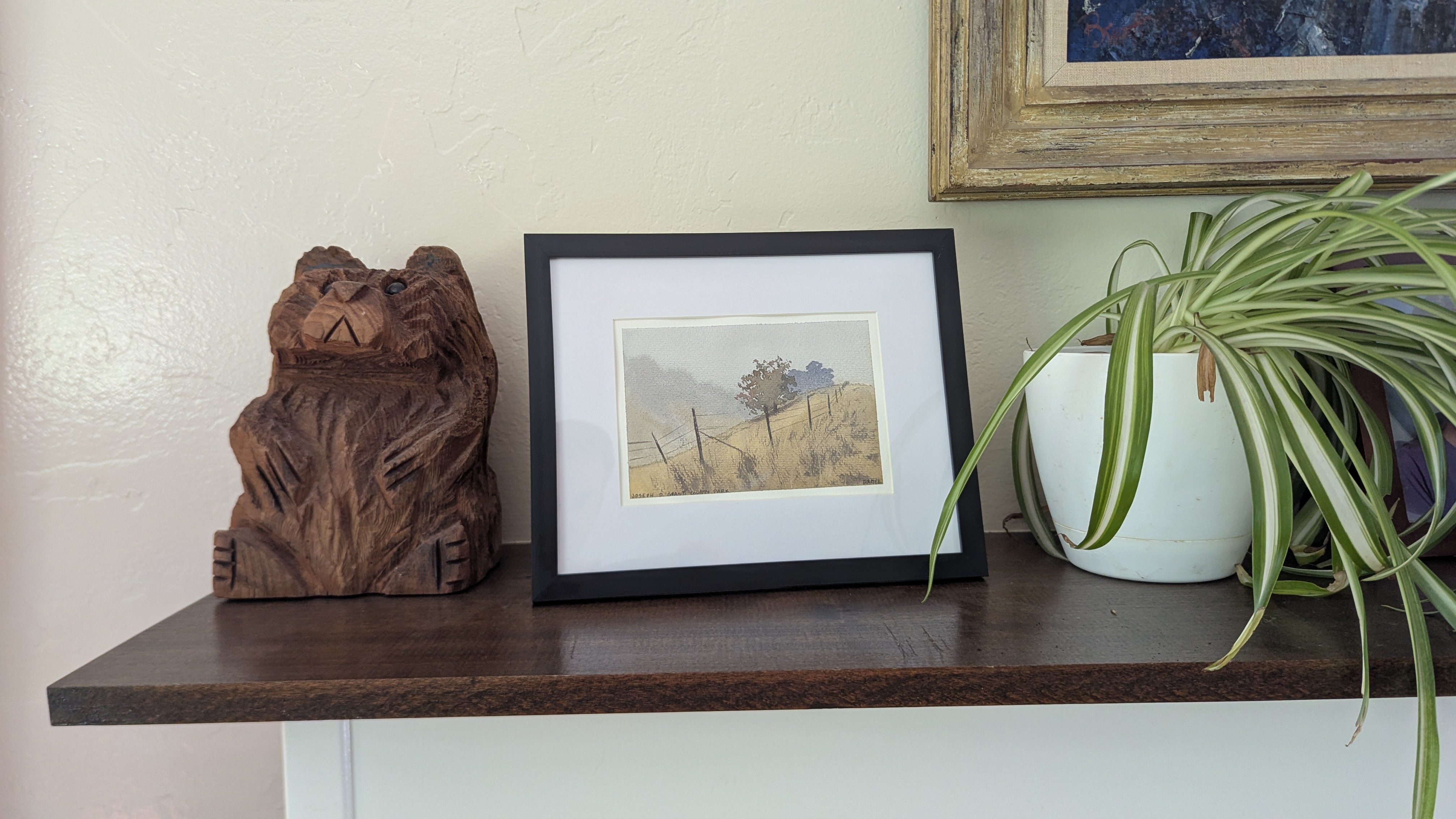 Small watercolor painting of a foggy day at Joseph D. Grant County Park sitting on a mantel.