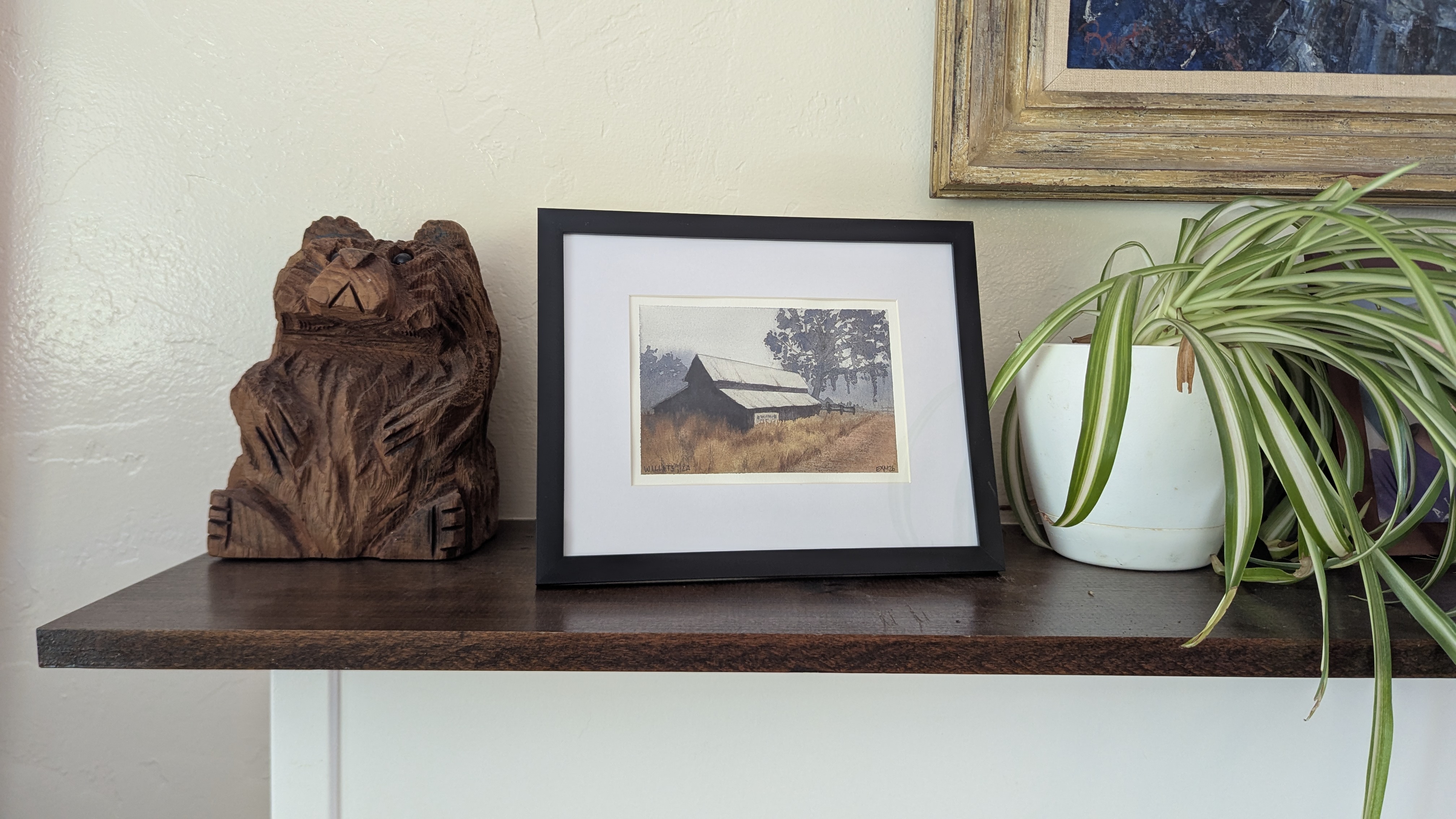 Watercolor painting of a barn in the morning fog in Willits, CA sitting on a mantel.